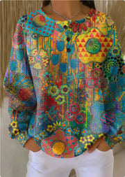 Colorful patterned blouse with long sleeves and a round neckline.